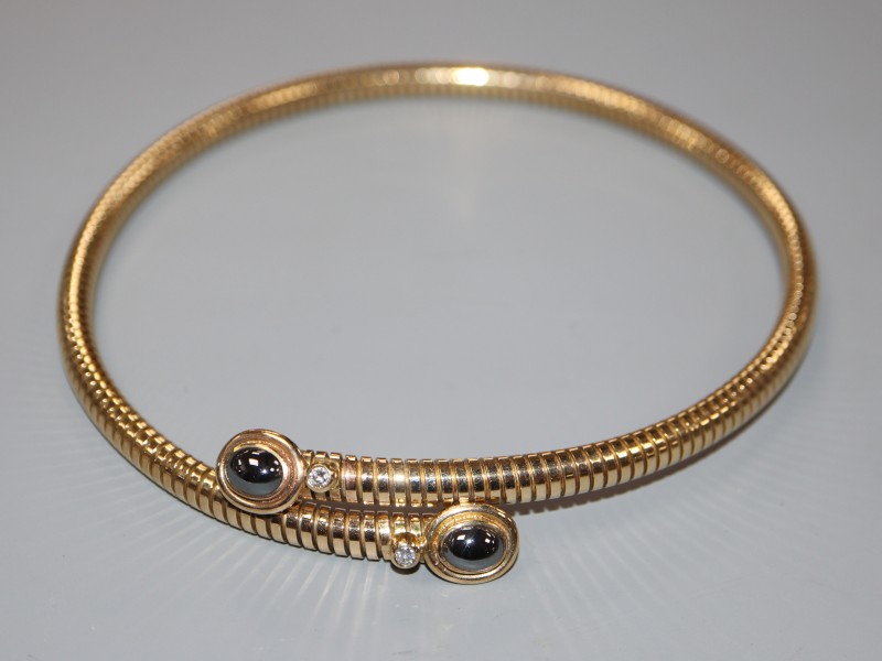 A modern 9ct gold, hematite and diamond mounted steel sprung necklet, gross weight 48.9 grams.